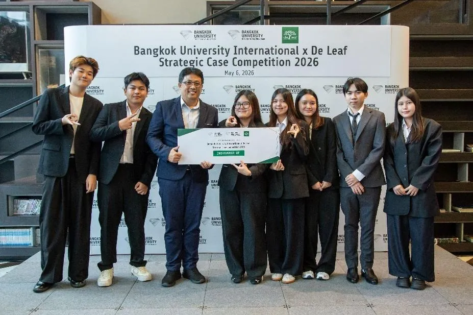 A group of people in professional attire is standing in front of a Bangkok University International x De Leaf sign, holding a certificate for the 2nd Runner-Up position in the Strategic Case Competition 2026.
AI-generated content may be incorrect.